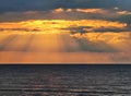 Magic sunset with dark storm clouds and penetrating sunbeams above the Baltic sea in Jurmala