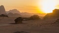 Magic sunset in Mountains of Wadi Rum Desert, Jordan. Red-brown mountains in last rays of  setting sun Royalty Free Stock Photo