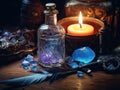 Magic vintage crystal bottle, birds feather, blue crystals, burning candle on a wooden table, cinematic style, close-up, selective Royalty Free Stock Photo