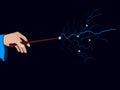 Magic wand. Hand holding a wand on a black background. Lightning spell. Royalty Free Stock Photo