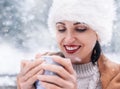 Magic winter moments - woman portrait with cup of hot tea in snow forest Royalty Free Stock Photo