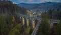 Magical aerial panorama of mystical Glebce viaduct close to Wisla, Poland in late autumn weather. Mysterious train bridge