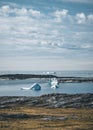 Magical arcticlandscape by Arctic Ocean in Greenland. Icebergs swimming in water. Blue sky on a summer day. Royalty Free Stock Photo