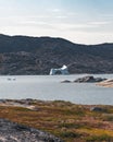 Magical arcticlandscape by Arctic Ocean in Greenland. Icebergs swimming in water. Blue sky on a summer day. Royalty Free Stock Photo