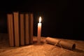 A magical ball, a scroll, a candle and an old book in the dark of the night Royalty Free Stock Photo