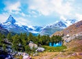 Magical beautiful autumn landscape with fir trees near lake on background Matterhorn in the Swiss Alps, near Zermatt, Switzerland