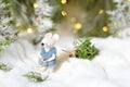 Magical Christmas decorations. A rat in a fur coat and with a Christmas tree in his hands Royalty Free Stock Photo