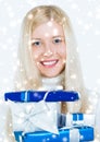 Magical Christmas and glitter snow background, happy blonde model with gift boxes in winter season for shopping sale and