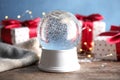 Magical empty snow globe with Christmas presents