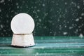 Magical Empty Snowglobe Falling Snow over Green Background