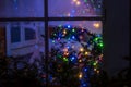 A magical fabulous winter window with toys and Christmas tree lights. Royalty Free Stock Photo