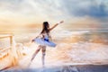 A magical fantastic photo of a ballerina girl in sea waves and spray.