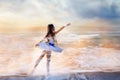 A magical fantastic photo of a ballerina girl in sea waves and spray.