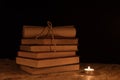 A magical ball, a scroll, a candle and an old book in the dark of the night