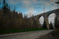 Magical ground view panorama of mystical Glebce viaduct close to Wisla, Poland in late autumn weather. Mysterious train bridge