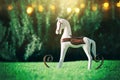 Magical image of vintage rocking horse in the garden at sunset Royalty Free Stock Photo