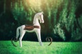 Magical image of vintage rocking horse in the garden at sunset Royalty Free Stock Photo