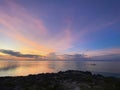 Magical landscape of beautiful sunset, dawn. Man sailing in boat in the sea.Blue sky on the horizon with colored clouds Royalty Free Stock Photo