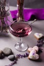 A magical lilac drink in a mysterious evening setting. Spiritual drink concept, magic close up.
