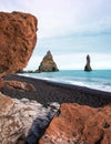 Magical majestic dramatic landscape with Reynisdrangar Sea Cliffs, stones called Troll under the Reynisfjall Mountain near Vik,