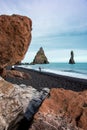 Magical majestic dramatic landscape with Reynisdrangar Sea Cliffs, stones called Troll under the Reynisfjall Mountain near Vik,