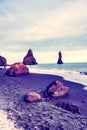 Magical majestic dramatic landscape with Reynisdrangar Sea Cliffs, stones called Troll under the Reynisfjall Mountain near Vik,