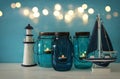 Magical mason jars whith candle light and wooden boat on the shelf Royalty Free Stock Photo