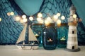 Magical mason jars whith candle light and wooden boat on the shelf. Glitter overlay Royalty Free Stock Photo