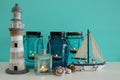 Magical mason jars whith candle light and wooden boat on the shelf. Nautical concept Royalty Free Stock Photo