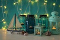 Magical mason jars whith candle light and wooden boat on the shelf. Nautical concept. Royalty Free Stock Photo