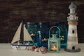 Magical mason jars whith candle light and wooden boat on the shelf. Nautical concept Royalty Free Stock Photo