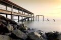 Magical moment during sunset with jetty and rock on the beach. some blur motion due to long exposure shoot