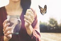 Magical moment of a woman who gives freedom to a butterfly