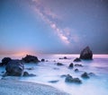 magical mystical beautiful charming landscape with waves and stones in the middle of the sea on the coast against the background Royalty Free Stock Photo