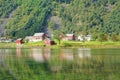 Magical Nature landscape with greenery, houses, water reflection Royalty Free Stock Photo