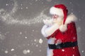 Magical photo of real Santa Claus blowing in snow. Merry Christmas and Happy New Year Royalty Free Stock Photo