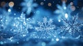 Magical shiny frozen snowflakes and snowfall sky, blue background with beautiful festive light bokeh, winter and Christmas Royalty Free Stock Photo