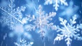 Magical shiny frozen snowflakes and snowfall sky, blue background with beautiful festive light bokeh, winter and Christmas Royalty Free Stock Photo