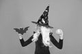 Magical spell. Small witch with white hair. Wizard or magician. Halloween party. Small girl in black witch hat. Autumn Royalty Free Stock Photo