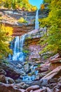 Magical stunning three tiered waterfalls from below pouring over layers of cliffs in peak New York fall foliage Royalty Free Stock Photo