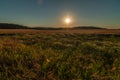 Summer evening landscape. Agricultural field is beautifully illuminated by the setting sun Royalty Free Stock Photo