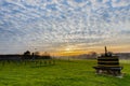 Magical sunset with a dramatic cloudscape in the rolling hills and the vineyards of Wijngaard op gen Heugde in South Limburg