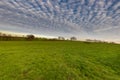 Magical sunset with a dramatic cloudscape in the rolling hills and the vineyards of Wijngaard op gen Heugde in South Limburg