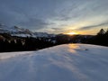 Magical sunset and shy sun behind winter clouds over the Obertoggenburg region and in the Swiss Prealps, UrnÃÂ¤sch / Urnaesch Royalty Free Stock Photo