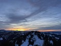 Magical sunset and shy sun behind winter clouds over the Obertoggenburg region and in the Swiss Prealps, UrnÃÂ¤sch / Urnaesch Royalty Free Stock Photo