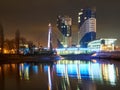 A magical view of the Kiss Bridge and the Admiral Business Class Residential Complex cast their glow on the water surface of the K