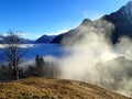 Magical winter landscape with fog inversion weatheres in the Alps - Vorarlberg Austria Europe Royalty Free Stock Photo