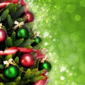 Magically decorated Fir Tree with balls, ribbons and garlands on a blurred Christmas-green shiny and sparkling background.