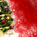 Magically decorated Fir Tree with balls, ribbons and garlands on a blurred Christmas-red shiny background
