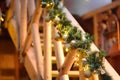 Magically decorated outdoor staircase with fir tree branches and garlands of golden balls. Celebration of Christmas holiday. Royalty Free Stock Photo